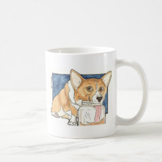 Corgi die op de pindakaas jar tikt koffiemok
