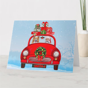 Corgi-hond in auto met kerstman kaart