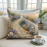 Cottage Garden Path to the Sea Kussen<br><div class="desc">This dreamy watercolor captures a sunlit stone path winding through a lush cottage garden bursting with roses, foxglove, and lavender, leading to a serene beach at low tide. Soft waves shimmer beneath a pale sky, while a cozy bench and wicker basket tucked among white picket fences add a sense of...</div>