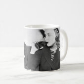 Coupled sitting together in a restaurant flirting  koffiemok (Voorkant rechts)