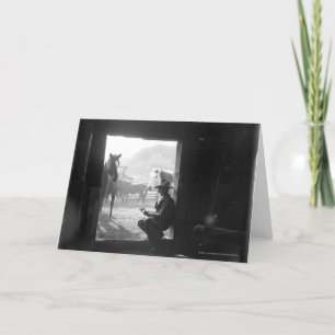 Cowboy in een deuropening met paarden kaart