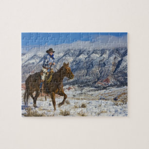 Cowboy op paard die leren chaps draagt legpuzzel