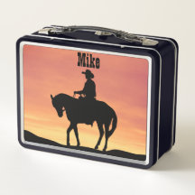 Cowboy te paard bij zonsondergang