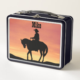 Cowboy te paard bij zonsondergang