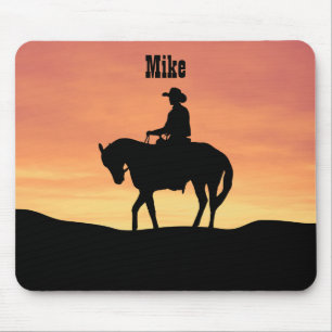 Cowboy te paard bij zonsondergang muismat