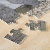 Cowboylaarzen en pet buiten de logcabine legpuzzel (Zijkant)