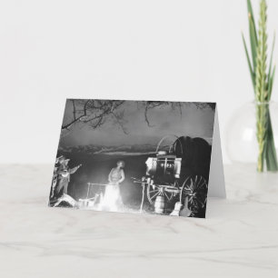 Cowboys spelen en zingen rond een kampvuur kaart