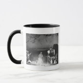 Cowboys spelen en zingen rond een kampvuur mok (Links)