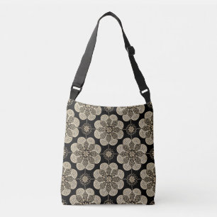 Crossbody tas met geelbruine medaillons op zwart