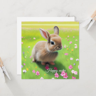 Cute baby rabbit in een bloemwei