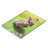 Cute baby rabbit in een bloemwei notitieboek (Linkerzijde)