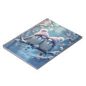 Cute budgies with bobble hats on a branch notitieboek (Linkerzijde)