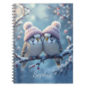 Cute budgies with bobble hats on a branch notitieboek (Voorkant)