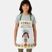 Cute cook cartoon personage met cupcakes schort (Insitu)