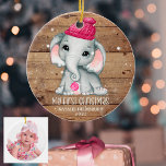 Cute Elephant Girl Baby's EERSTE CHRISTMAS Rustic Keramisch Ornament<br><div class="desc">Creëer een herdenkingsfoto-ornament voor het eerste kerstfeest van een baby meisje met een schattige jonge olifant met een roze pet met een kerstboomachtergrond en sneeuwval met de titel MY FIRST CHRISTMAS, met een naam en een jaar op de voorkant en een baby op de achterkant. PHOTO TIP: Kies een foto...</div>