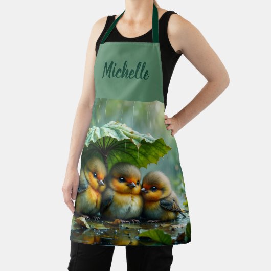 Cute fluffy birds hiding under leaf in rain schort (Insitu)