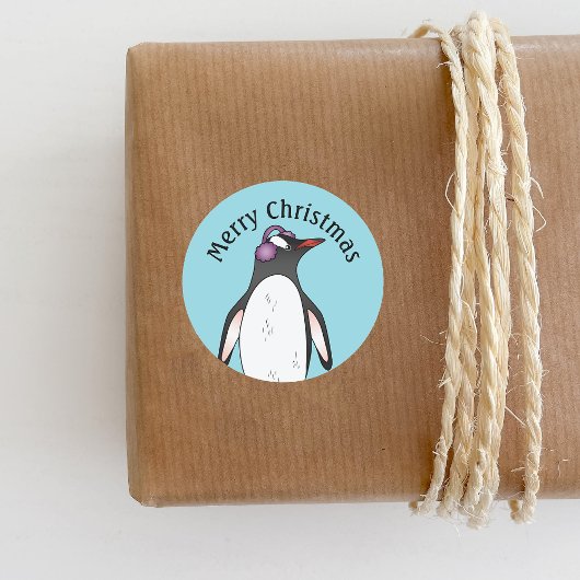 Cute Gentoo Penguin die de oorbescherming op blauw Ronde Sticker