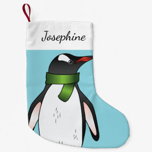 Cute Gentoo Penguin die een groen karf op blauw he Kleine Kerstsok