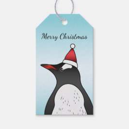 Cute Gentoo Penguin die een kersthat op blauw heef Cadeaulabel