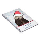 Cute Otter die met Kerstmis een kerstman heeft. Notitieboek (Rechterzijde)