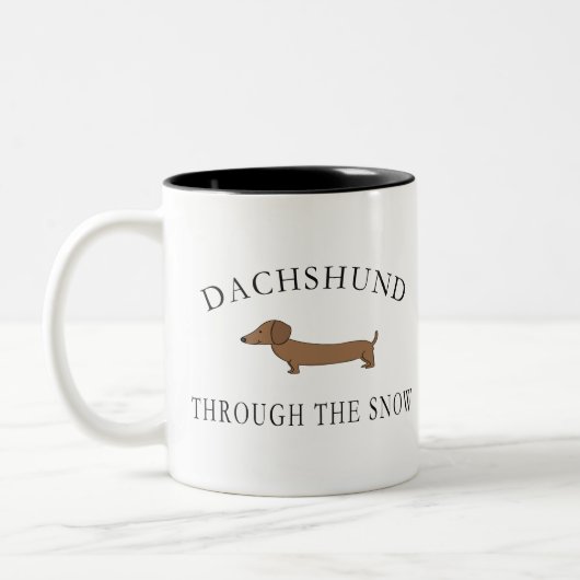 Dachshund door de sneeuw tweekleurige koffiemok (Links)