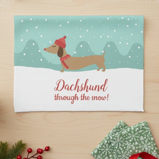 Dachshund door de sneeuwhanddoek theedoek