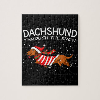Dachshund door de sneeuwnende hond kerstmis legpuzzel