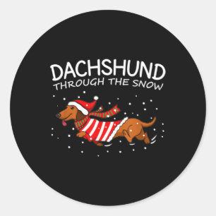 Dachshund door de sneeuwnende hond kerstmis ronde sticker