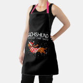 Dachshund door de sneeuwnende hond kerstmis schort (Insitu)