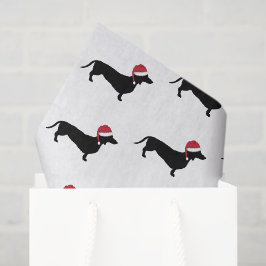 Dachshund in een kerstkerstman met kerstmis tissuepapier