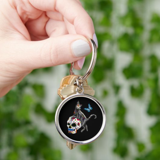 Dag van de dode kattensuikerschedel en vlinder sleutelhanger (Hand)