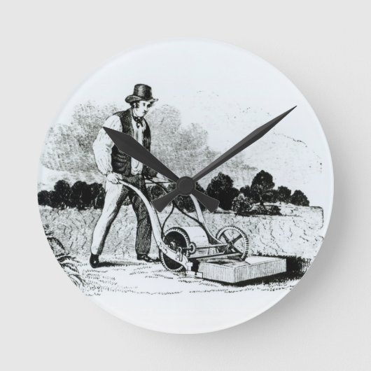 De eerste grasmaaier (graving) (foto) ronde klok (Voorkant)