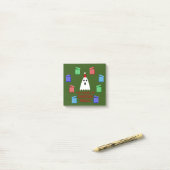 De gastheer van Kerstmis presenteert grappig Post-it® Notes (Op bureau)