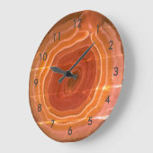 De gespleten oranje stenen klok met cijfers. (Hoek)