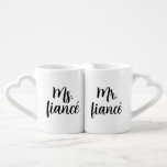 De heer en mevrouw Fiancé Coffee Mok Set<br><div class="desc">Voeg wat plezier toe aan je ochtenden met deze Mr en Ms. Fiancé Coffee Mok Set met inktzwarte trendy letters. Met een stijlvol, eigentijds script en een gedurfd, modern design is deze set ideaal voor koppels die hun verloving vieren. Of je nu koffie, thee of warme cacao drinkt, deze mokken...</div>
