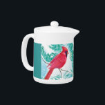 De kardinaal - theepot<br><div class="desc">Dit ontwerp bevat een rode kardinaal die op een sneeuwbedekte tak zit. De vogel kijkt naar de sneeuwvlokken die uit de lucht vallen en de grond bedekken. De bomen rond de vogel zijn ook sneeuw bedekt. Voor deze theepot wordt een groene achtergrond gebruikt.</div>