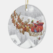 De kerstman rijdt op een slee met cadeaudoos keramisch ornament (Links)