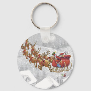 De kerstman rijdt op een slee met cadeaudoos sleutelhanger