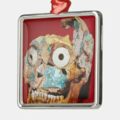 De schedel is versierd met een mozaïek in turkoois metalen ornament (Links)