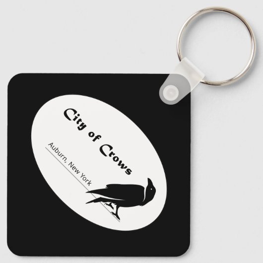 De stad van de kraaien Logo Sleutelhanger (Achterkant)