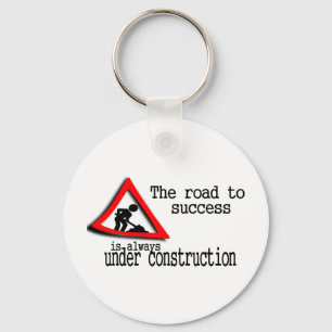 De weg naar succes is altijd in aanbouw sleutelhanger