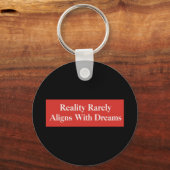 De werkelijkheid komt zelden overeen met dromen sleutelhanger (Achterkant)