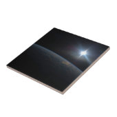 De zon gaat onder aan de horizon van de aarde. tegeltje (Zijkant)