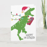 Derpy t-rex dinosaurus kerstlampjes Santa hat Feestdagen Kaart<br><div class="desc">Fijne,  belachelijke T-Rex of tyrannosaurus rex dinosaur met een kersthoed met een belletje en een grote glimlach,  die met een cadeau 4 Yoo en kerstlichten op deze vakantiekaart voor kinderen van alle leeftijden loopt.</div>