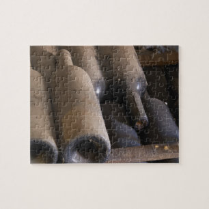 Detail van stoffige flessen op latten op houten legpuzzel
