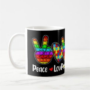 Deze nieuwsuitgave met Gezegden "Peace Love Autis" Koffiemok