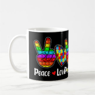 Deze nieuwsuitgave met Gezegden "Peace Love Autis" Koffiemok