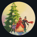 Dickens style Christmas illustration Ronde Sticker<br><div class="desc">Old English Dickens style Christmas illustration with a family standing in the snow in front of a Christmas tree with bright burning candles.</div>