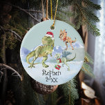 Dinosaur Kerstman Tyrannosaur Raptor Keramisch Ornament<br><div class="desc">Dit ontwerp kan op het gebied worden gepersonaliseerd dat door de foto en/of tekst te veranderen wordt verstrekt. Of het kan worden aangepast door te klikken deze Sjabloon personaliseert en dan de klik te kiezen om verdere optie aan te passen en de kleur van de achtergrond te schrappen of te...</div>