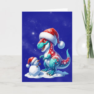 Dinosaur met kerstmuts bouwt een sneeuwman feestdagen kaart